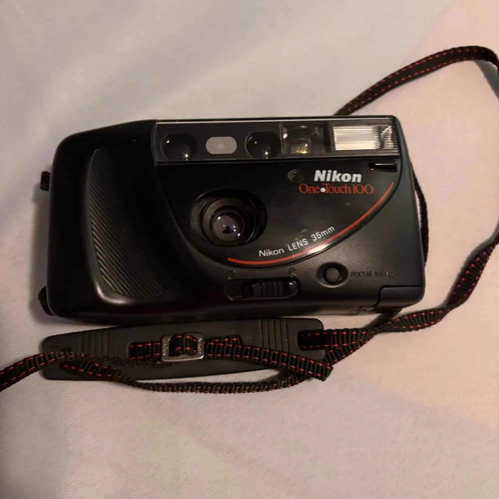 Nikon Black Camera with Red Accents and Case don’t know if it works